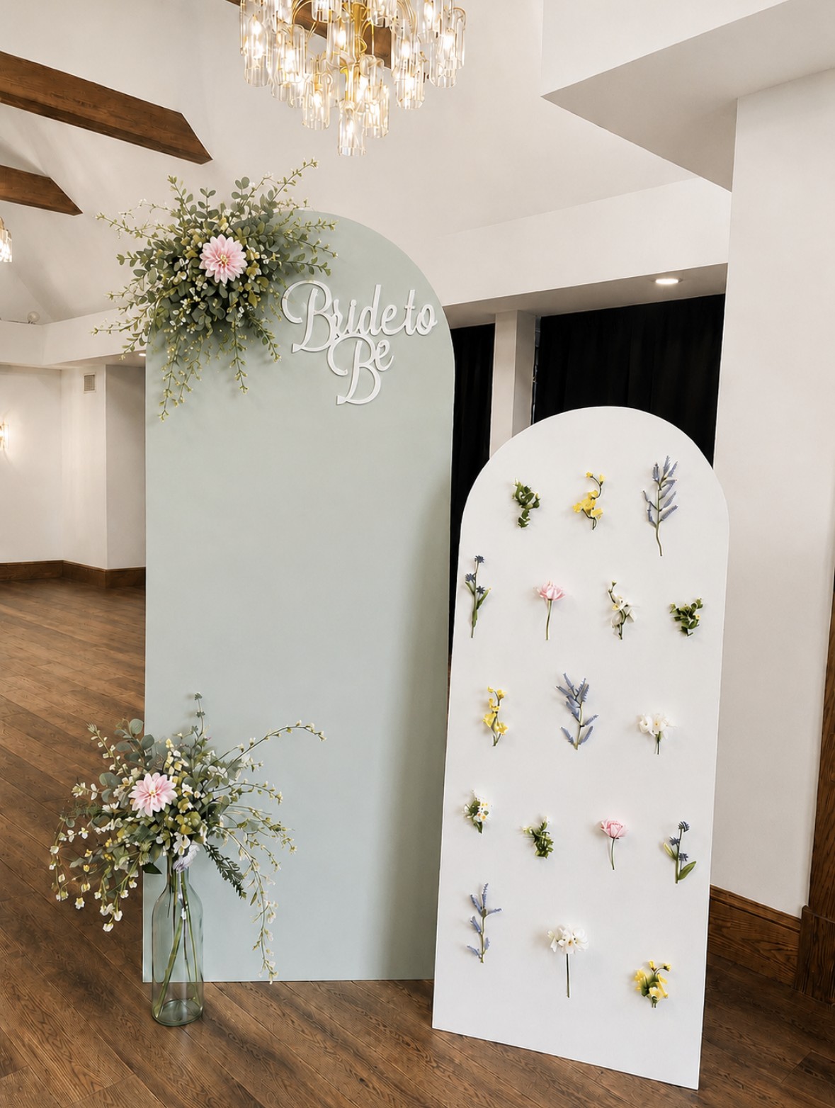 Ivory bridal shower backdrop panels decorated with pressed flowers and soft floral arrangements