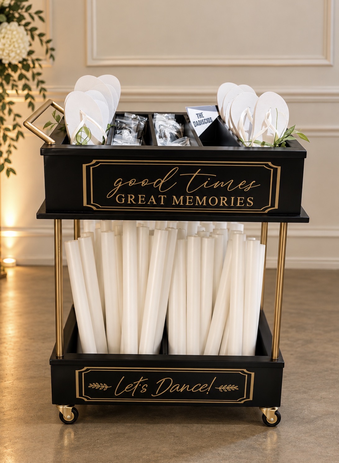 Black dance-floor cart filled with flip-flops, sunglasses, and glow accessories